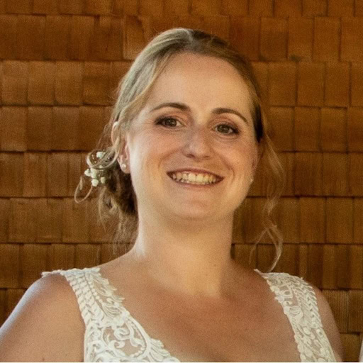 Woman in wedding dress smiling happily.