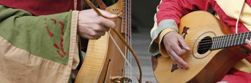 Musicians play historical string instruments.